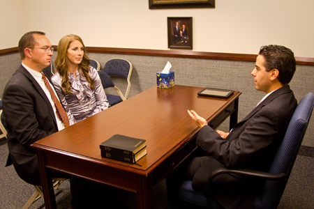 Bishop speaks with a couple in his office