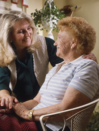 an elderly woman with a younger woman, both smiling