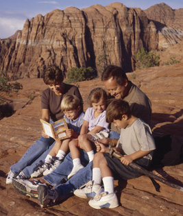 A family sitting together in an outdoor environment.